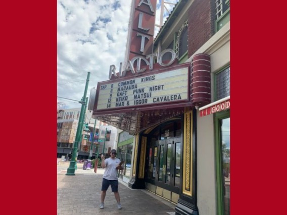Man smiling in front of The Rialto Theater in Tucson.