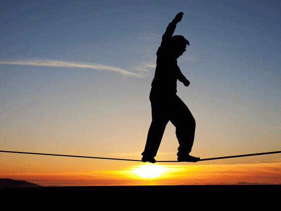 Person on high wire at sunrise