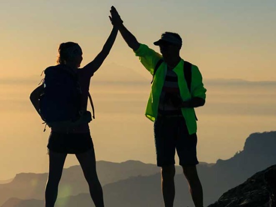 Man and woman celebrating on mountaintop